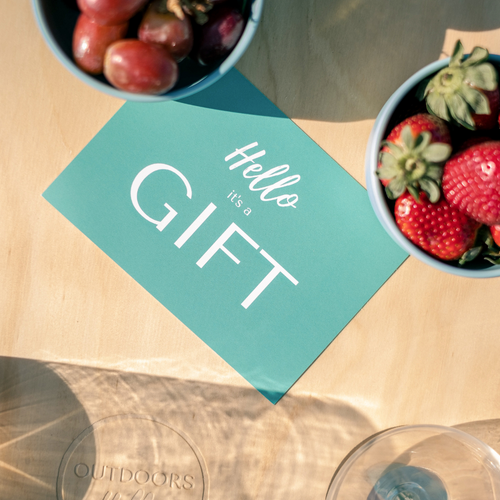 Close up of Hello It's a Gift Greeting gift card on a Deluxe 4 Glass Folding Picnic Table